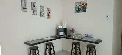 a kitchen with a counter with three bar stools at Setia Residen Semi-D two half storey 5 Bedrooms unlimited wifi in Sitiawan