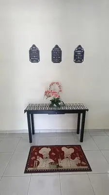 a bench in a room with a rug and signs on the wall at Setia Residen Semi-D two half storey 5 Bedrooms unlimited wifi in Sitiawan
