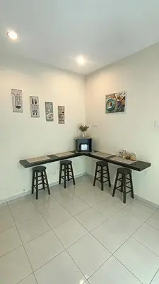 a kitchen with two tables and two stools at Setia Residen Semi-D two half storey 5 Bedrooms unlimited wifi in Sitiawan