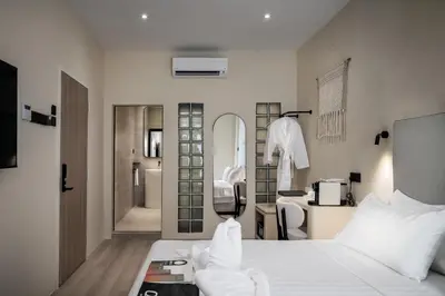 a bedroom with a white bed and a bathroom at Muntri Maison in George Town