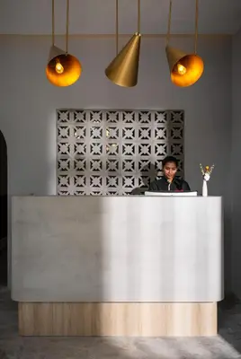 a man sitting at a counter behind a white counter top at Muntri Maison in George Town