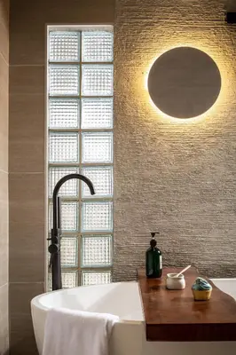 a bath tub in a bathroom with a large window at Muntri Maison in George Town