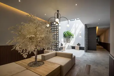 a living room with a couch and a tree at Muntri Maison in George Town
