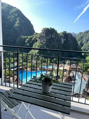 a balcony with a bench and a view of the beach at Ipoh Sunway Onsen Suites and Tambun Guesthouse , 3-14pax 2parking by IWH in Ipoh