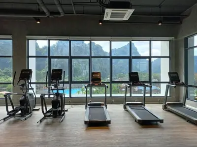 a gym with a bunch of exercise bikes in a room at Ipoh Sunway Onsen Suites and Tambun Guesthouse , 3-14pax 2parking by IWH in Ipoh