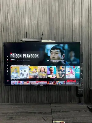 a large television screen with a movie on it at SAMSARA Studio Apartment at Kompleks Mutiara GM in Gua Musang
