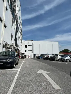 a street with cars parked in a parking lot at SAMSARA Studio Apartment at Kompleks Mutiara GM in Gua Musang