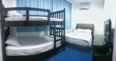a room with two bunk beds and a desk at 246housecafe in George Town