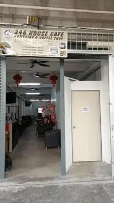 a building with a white door and a sign above it at 246housecafe in George Town