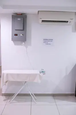 a hospital room with a table in a white wall at Heritage Inn in George Town