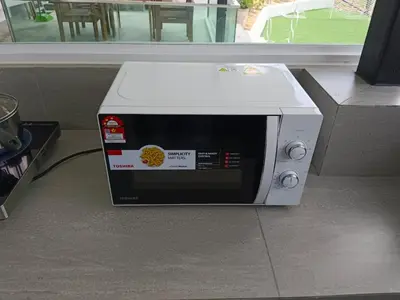 a microwave oven sitting on the floor next to a window at I Do Farmstay in Bukit Mertajam
