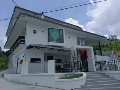 a white house with a staircase in front of it at I Do Farmstay in Bukit Mertajam