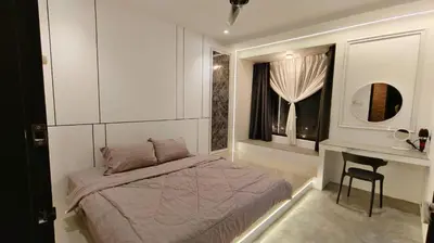 a bedroom with a bed and a desk and a window at I Do Farmstay in Bukit Mertajam