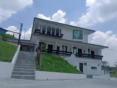 a white house with stairs in front of it at I Do Farmstay in Bukit Mertajam