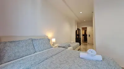 a bedroom with a bed with a book on it at Rooms at Mansion One, Shared Apartment Only in George Town