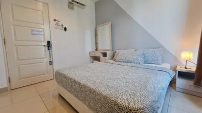 a small bedroom with a bed and a white door at Rooms at Mansion One, Shared Apartment Only in George Town