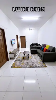 a living room with a couch and a coffee table at HomeSTAY PANGSAPURI SAMUDERA SERI MANJUNG LUMUT in Seri Manjung