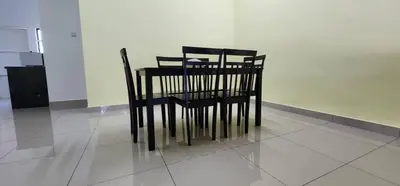 a black table and chairs sitting on a tiled floor at Bertam Homestay Kepala Batas in Kepala Batas