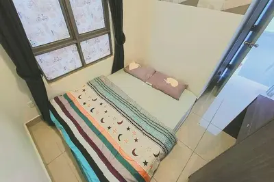 a small bed in a room with a window at Freezing Point Homestay @ Palas Horizon Residence in Cameron Highlands