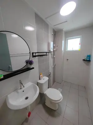 a bathroom with a sink and a toilet and a mirror at Casa Apartment @ Ipoh \u3010\u6021\u4fdd\u6c11\u5bbf\u3011 in Ipoh