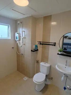 a bathroom with a toilet and a shower and a sink at Casa Apartment @ Ipoh \u3010\u6021\u4fdd\u6c11\u5bbf\u3011 in Ipoh