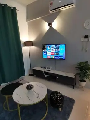 a living room with a table and a tv on the wall at Casa Apartment @ Ipoh \u3010\u6021\u4fdd\u6c11\u5bbf\u3011 in Ipoh
