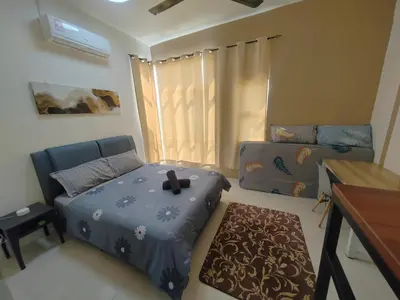 a small bedroom with a bed and a desk at Casa Apartment @ Ipoh \u3010\u6021\u4fdd\u6c11\u5bbf\u3011 in Ipoh