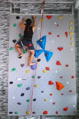 a person is on the climbing wall at Private Rock Climb at The CEO Penang in Bayan Lepas