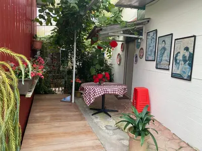 a patio with a table and a red chair at New Farmer Hut 2 in Brinchang