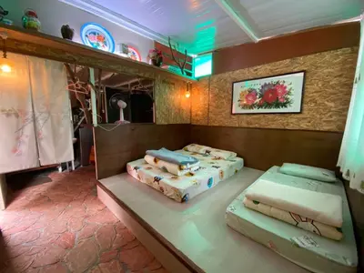 a room with two beds and a mirror at New Farmer Hut 2 in Brinchang
