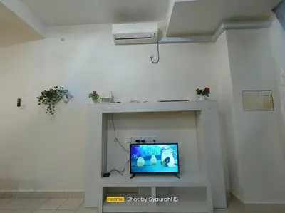 a tv sitting on a shelf in a room at Syaurah Homestay Bagan Serai Dua Tingkat 4 Bilik in Bagan Serai