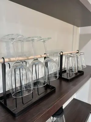 a row of wine glasses sitting on a shelf at Ipoh Town - Octagon Cozy Deluxe Homestay in Ipoh