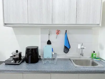 a kitchen with a counter top with a sink and a counter top at Ipoh Town - Octagon Cozy Deluxe Homestay in Ipoh
