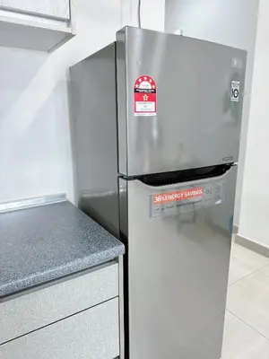 a stainless steel refrigerator with a red sticker on it at Ipoh Town - Octagon Cozy Deluxe Homestay in Ipoh