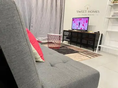 a living room with a couch and a television at R&W 1-5pax B'worth Prai #Netflix #6minPenangBridge in Perai
