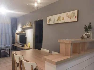 a living room with a wooden table and a dining room at Emerald Avenue Cozy 1BR Studio Suite in Brinchang