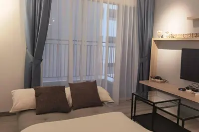 a living room with a couch and a television at Emerald Avenue Cozy 1BR Studio Suite in Brinchang