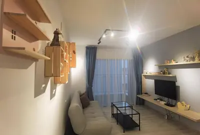 a living room with a couch and a television at Emerald Avenue Cozy 1BR Studio Suite in Brinchang