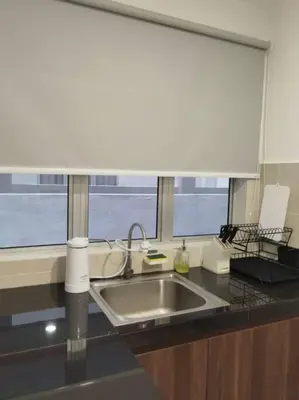 a kitchen counter with a sink and a window at Emerald Avenue Cozy 1BR Studio Suite in Brinchang