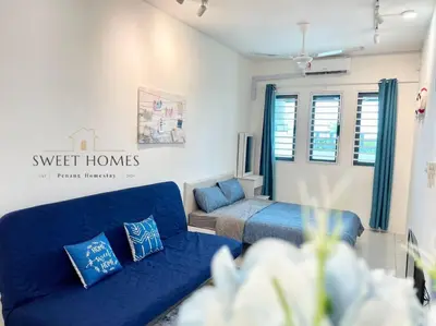 a living room with a blue couch and a bed at Blue Studio Suite 1-4pax B'Worth Prai@SwimmingPool in Perai