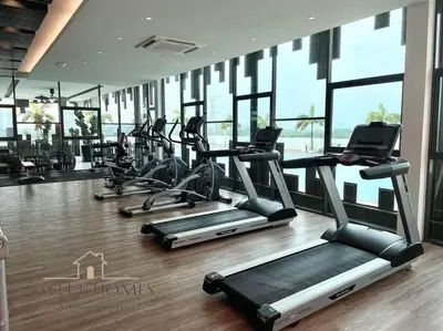 a gym with several tread machines in a room with windows at Blue Studio Suite 1-4pax B'Worth Prai@SwimmingPool in Perai
