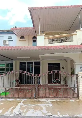 a house with a wooden porch with a fence at HELLO HOMESTAY in Nibung Tebal