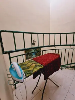 a bed with a table and a chair in a room at HELLO HOMESTAY in Nibung Tebal