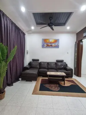 a living room with a couch and a ceiling fan at HELLO HOMESTAY in Nibung Tebal