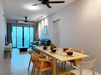 a dining room and living room with a table and chairs at JOVIAL Modern Cozy Homestay `Meritus Perai in Perai