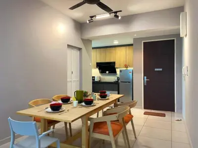 a kitchen and dining room with a table and chairs at JOVIAL Modern Cozy Homestay `Meritus Perai in Perai