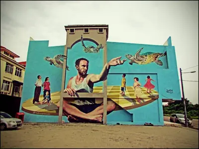 a mural of a man on a surfboard on a building at Cheerful 3-Bedroom Residential Home with Free WIFI in Butterworth