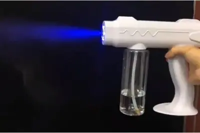 a person holding a plastic gun in a beaker of water at Cheerful 3-Bedroom Residential Home with Free WIFI in Butterworth