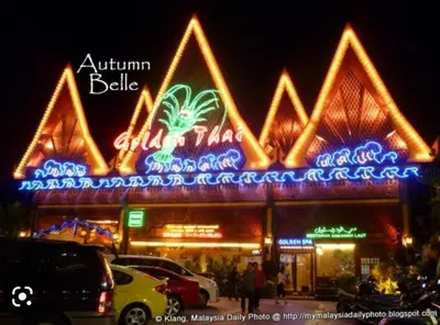 a building with a lot of neon lights on it at Have a pleasant stay with Bayu Emas Homestay in Batu Ferringhi