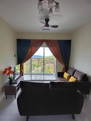 a living room with a couch and a large window at Alyaleesya Emerald avenue 4 Brinchang for muslim in Brinchang